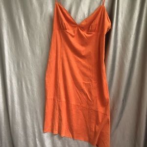 Orange suede dress with asymmetrical hem.